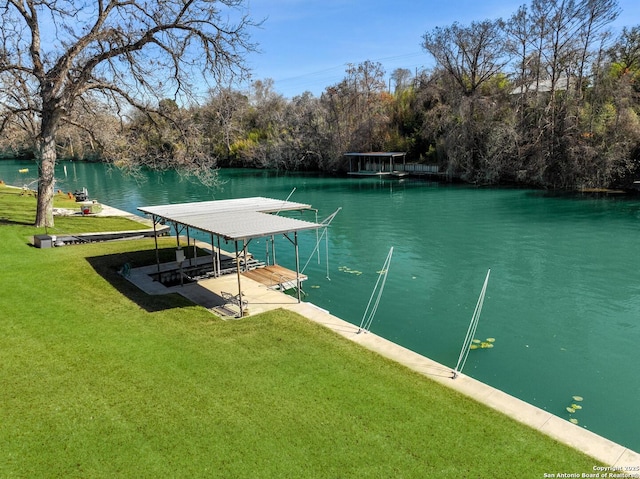 view of dock with a water view and a lawn