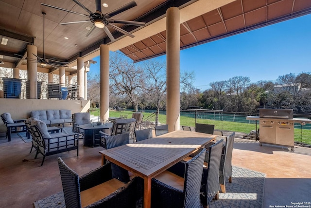 view of patio with an outdoor living space, grilling area, and ceiling fan