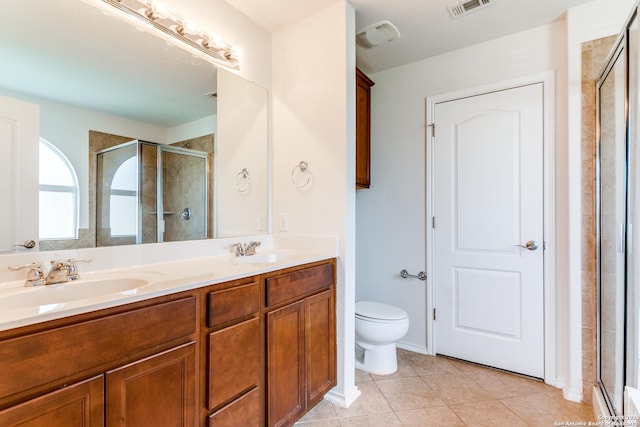 bathroom featuring vanity, tile patterned floors, toilet, and walk in shower