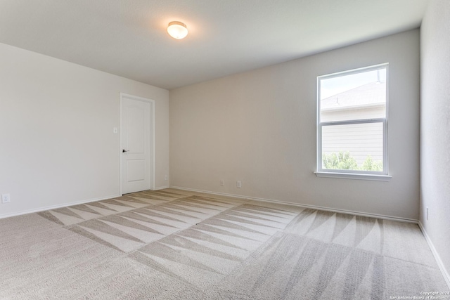 empty room featuring light colored carpet