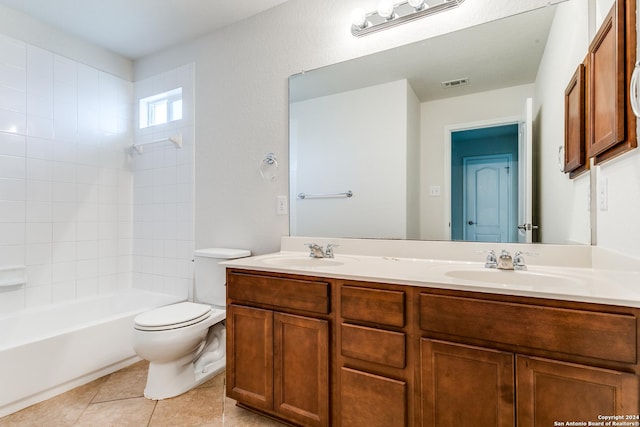 full bathroom featuring tile patterned floors, toilet, tiled shower / bath combo, and vanity