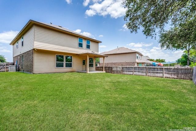 back of house featuring central AC, a lawn, and a patio area