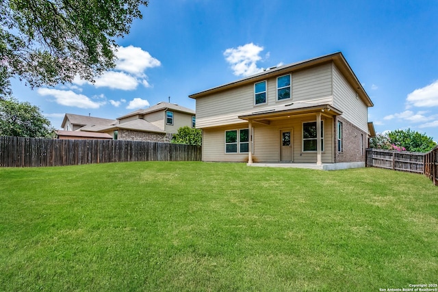 rear view of house with a patio area and a lawn