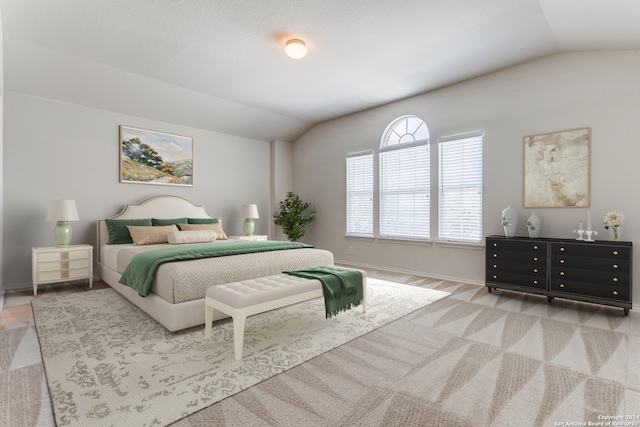 bedroom with light colored carpet and vaulted ceiling