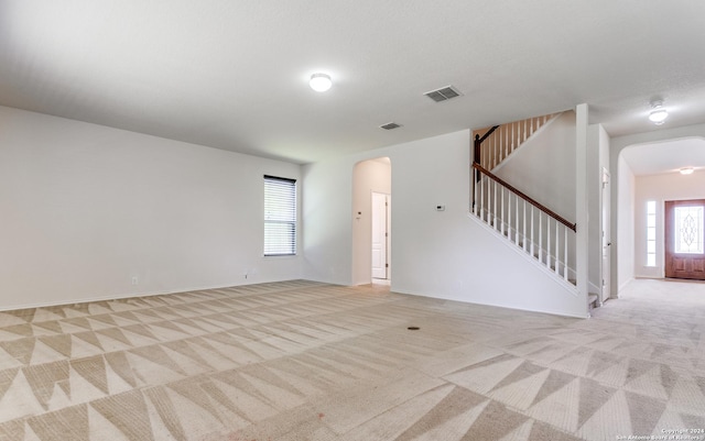 unfurnished living room with light carpet