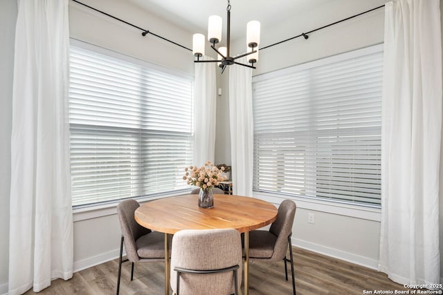 dining area featuring hardwood / wood-style flooring and a notable chandelier