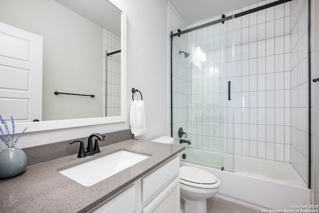 full bathroom featuring vanity, tile patterned floors, toilet, and combined bath / shower with glass door