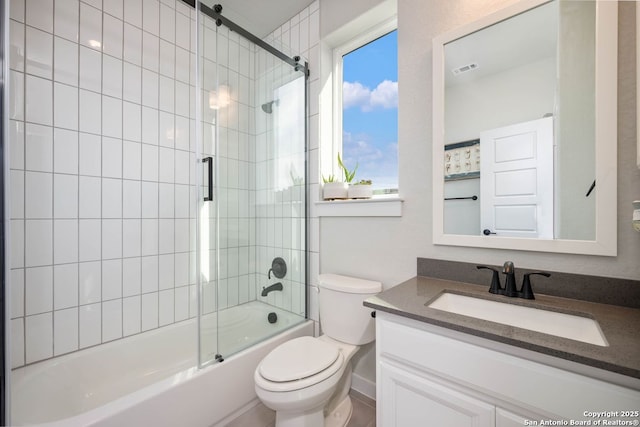 full bathroom with vanity, shower / bath combination with glass door, and toilet