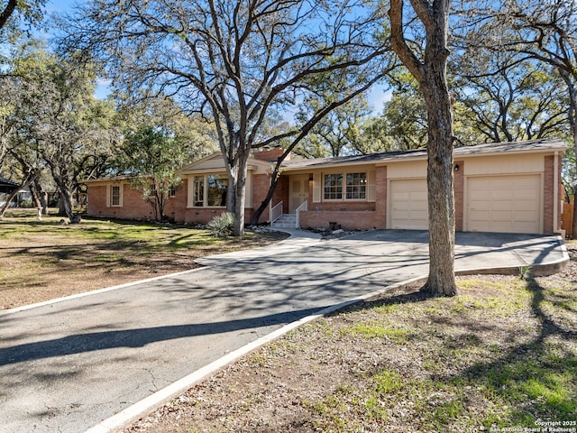 single story home with a garage and a front yard