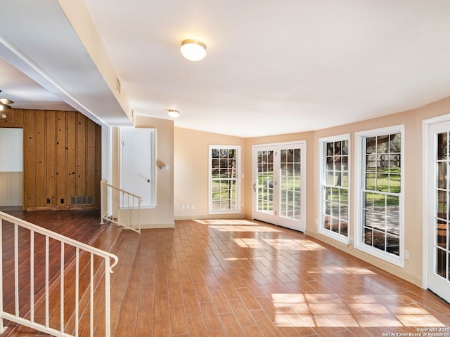 interior space featuring hardwood / wood-style flooring and wood walls