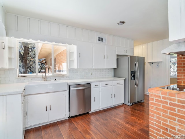 kitchen with appliances with stainless steel finishes, sink, white cabinets, and dark hardwood / wood-style flooring