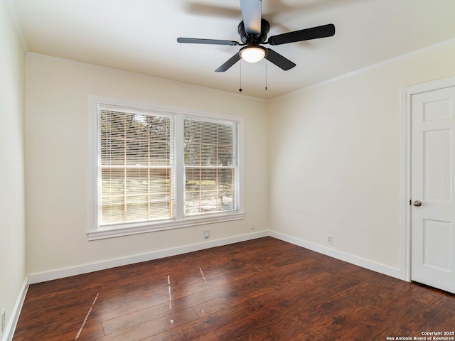 spare room featuring dark wood-type flooring, ceiling fan, and crown molding