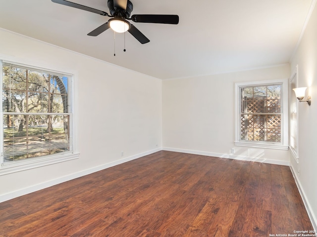 spare room with ornamental molding, dark hardwood / wood-style floors, and ceiling fan