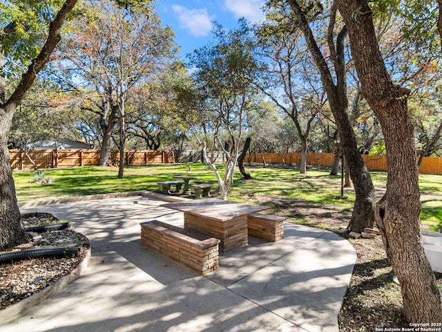 view of community featuring a yard and a patio area