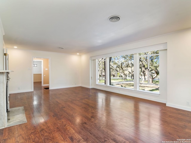 unfurnished living room with crown molding and dark hardwood / wood-style floors