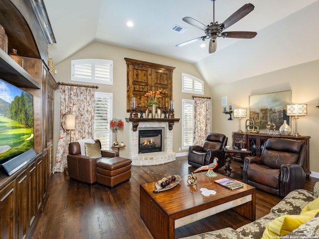 living room featuring vaulted ceiling, a brick fireplace, ceiling fan, and dark hardwood / wood-style flooring