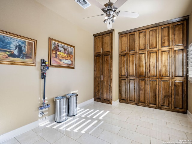 interior space with ceiling fan