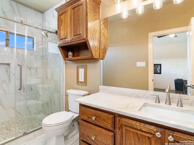 bathroom featuring vanity, an enclosed shower, and toilet