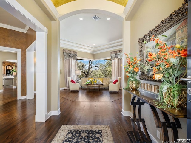 entryway with crown molding and dark hardwood / wood-style flooring