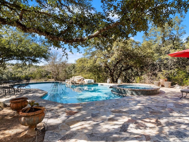 view of swimming pool with a patio and an in ground hot tub