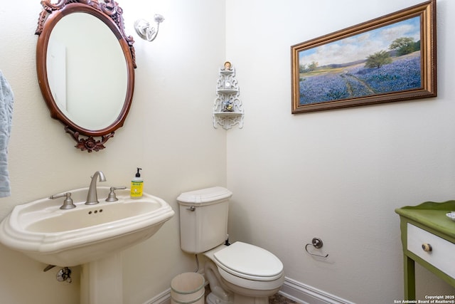 bathroom featuring toilet and sink