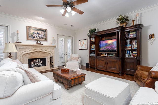 living room featuring hardwood / wood-style flooring, ornamental molding, and plenty of natural light