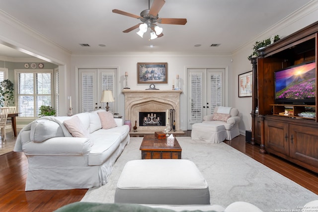 living room featuring crown molding, dark hardwood / wood-style flooring, and french doors