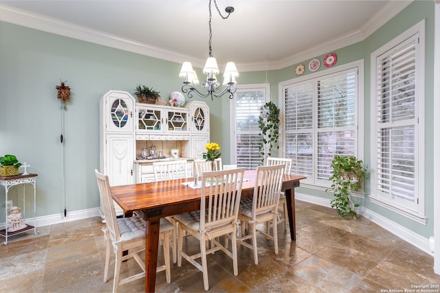 dining space featuring crown molding and a notable chandelier