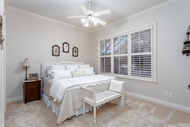 carpeted bedroom with ornamental molding and ceiling fan