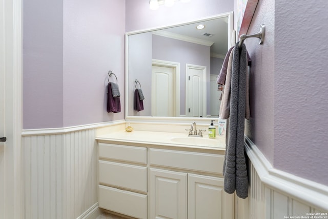 bathroom featuring ornamental molding and vanity