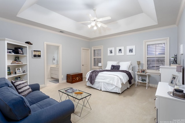 bedroom with crown molding, light colored carpet, and a raised ceiling