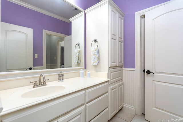 bathroom featuring crown molding, vanity, and tile patterned floors