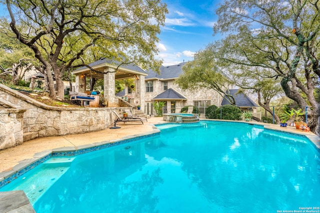 view of pool featuring a gazebo and an in ground hot tub