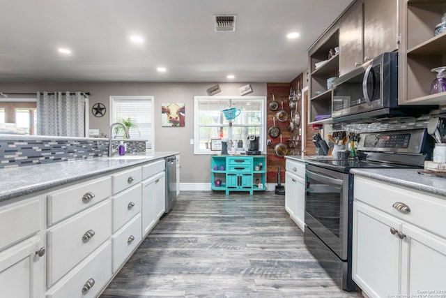 kitchen with dark hardwood / wood-style flooring, sink, white cabinets, and appliances with stainless steel finishes