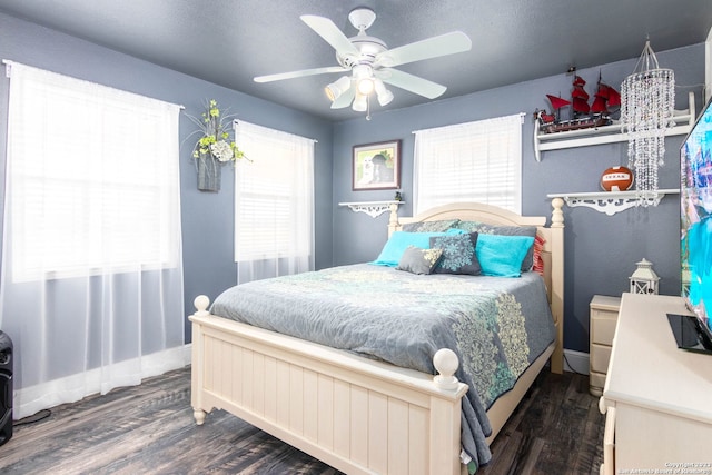 bedroom with dark wood-type flooring and ceiling fan