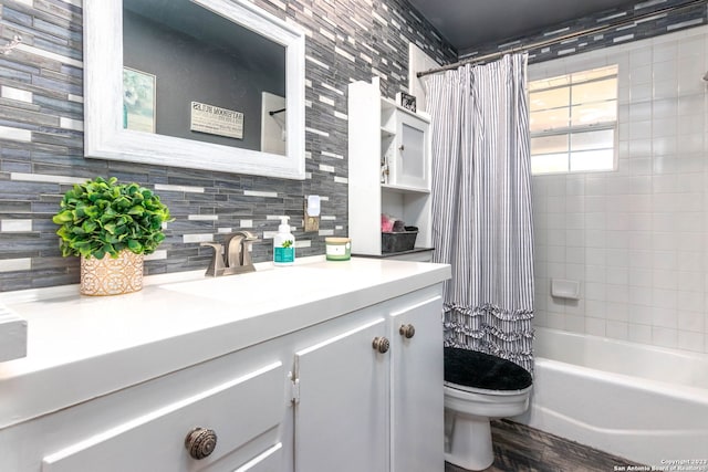 full bathroom with vanity, decorative backsplash, toilet, and shower / bath combo