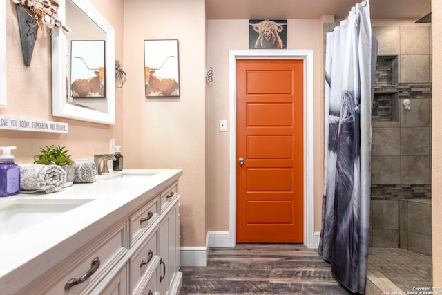 bathroom with a shower with curtain, vanity, and hardwood / wood-style floors