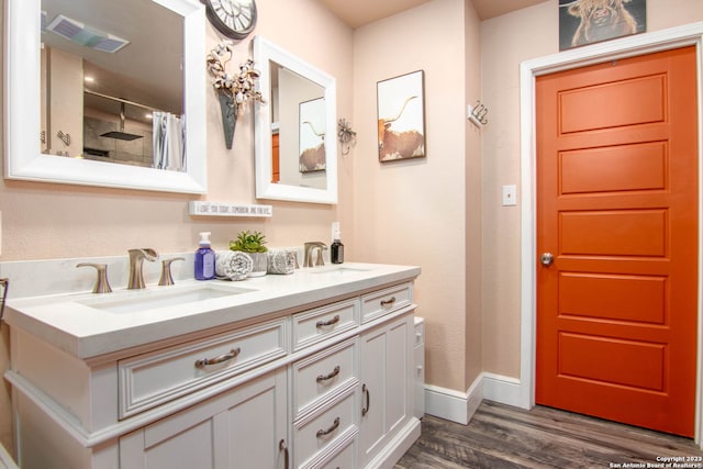 bathroom with vanity, hardwood / wood-style flooring, and curtained shower