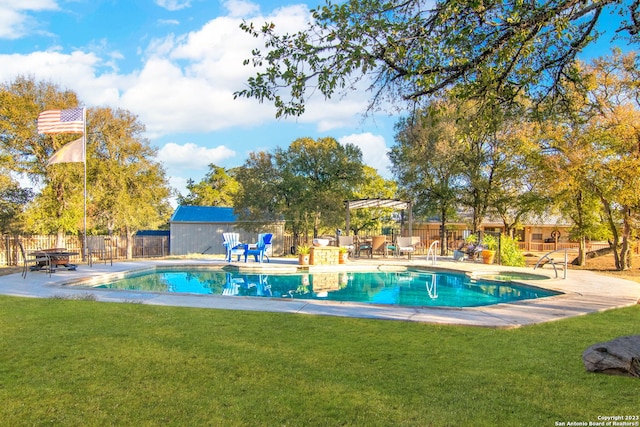 view of swimming pool featuring a pergola and a yard