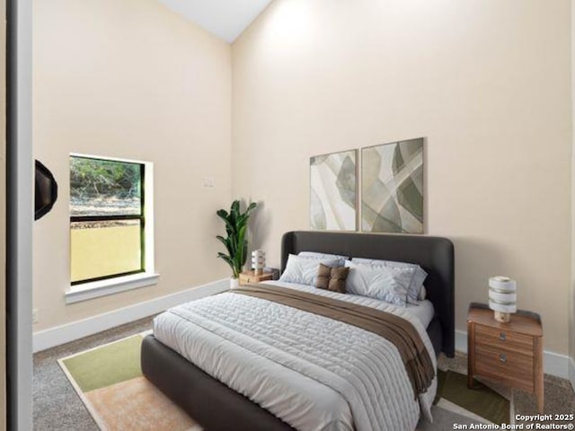 carpeted bedroom featuring high vaulted ceiling