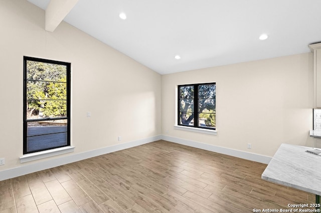 interior space with vaulted ceiling with beams and light hardwood / wood-style floors