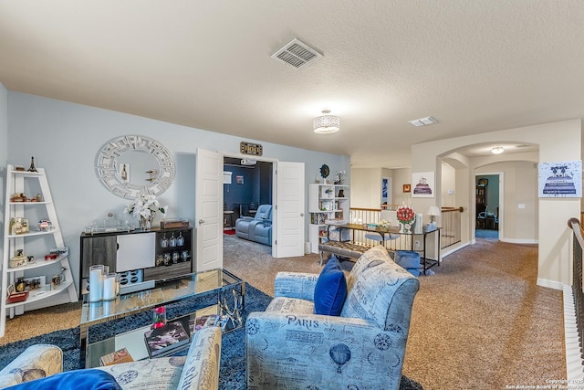 carpeted living room with a textured ceiling