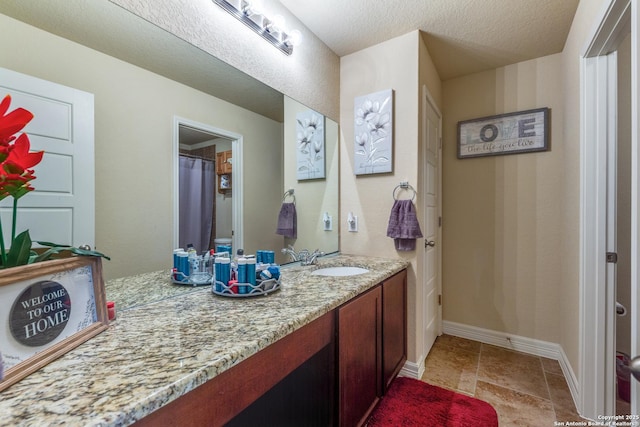 bathroom with vanity and a textured ceiling