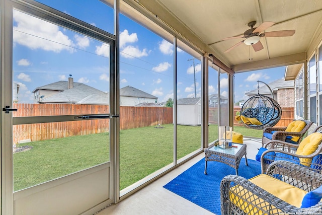 sunroom / solarium featuring ceiling fan