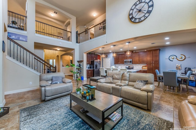 living room featuring a towering ceiling