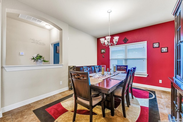 dining space featuring a notable chandelier