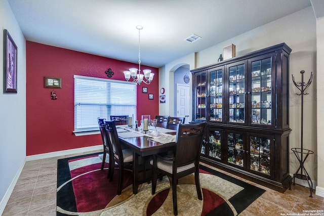 tiled dining area featuring a notable chandelier