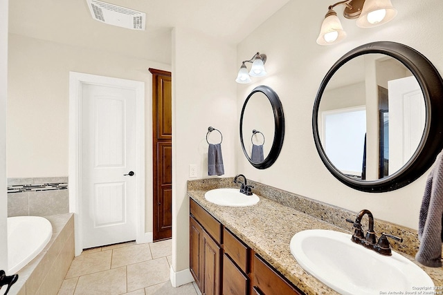 bathroom with vanity, tile patterned floors, and tiled bath