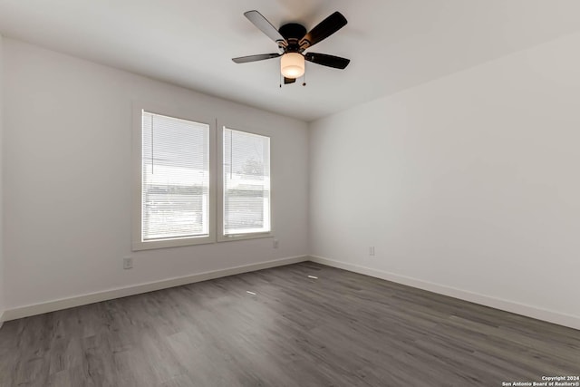 unfurnished room with dark wood-type flooring and ceiling fan