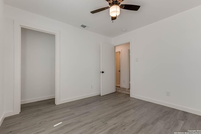 unfurnished bedroom featuring ceiling fan and light hardwood / wood-style flooring